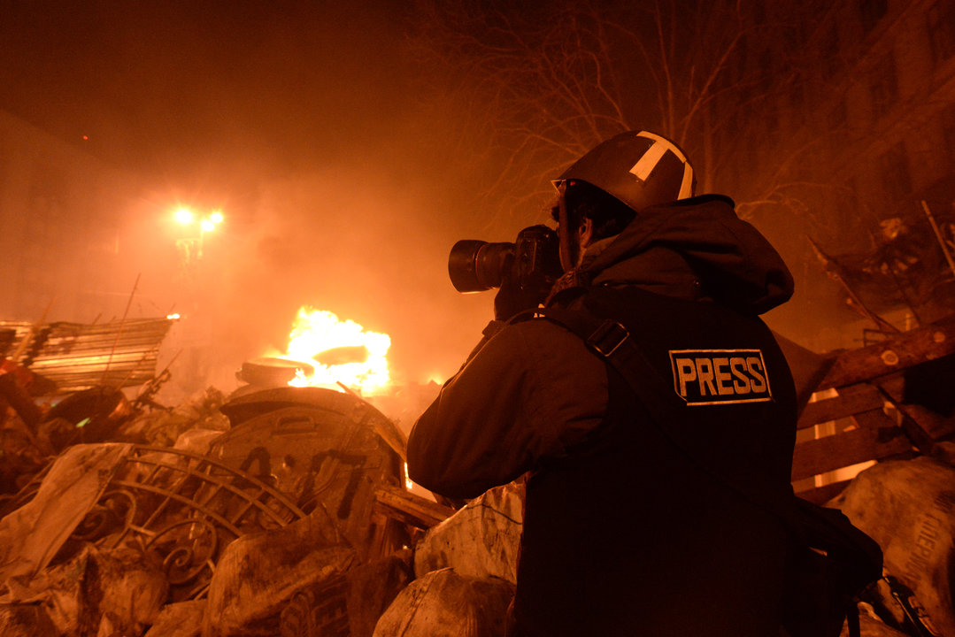 Journalist documenting events at the Independence square. Clashes in Ukraine, Kyiv. Events of February 18, 2014.