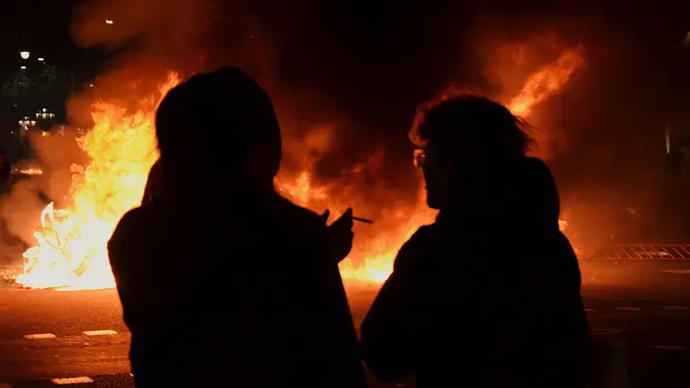 Abuela y madre supervisando la barricada que ha iniciado su hijo / DOBLECHECK